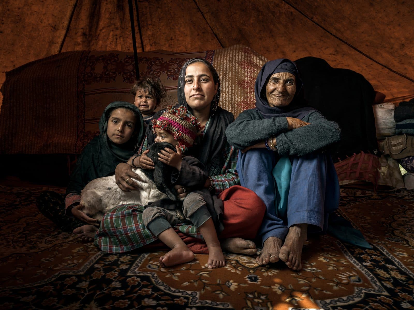Three generations inside a tent, Bakkarwal community